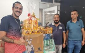 Imagem mostra dirigentes sindicais ao lado das doações de panetones