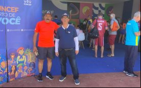 Fotografia mostra dois homens com roupas esportivas nas cores vermelho, azul e branco 